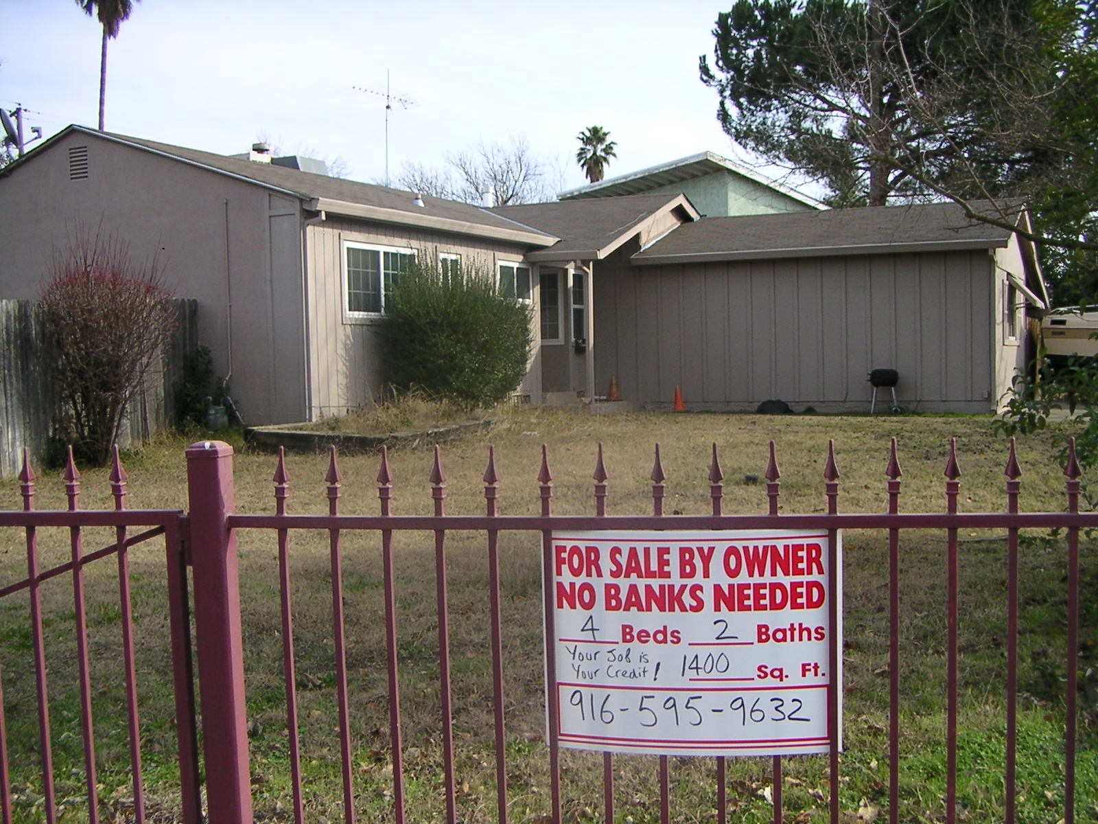 California housing market data 2026: for-sale sign outside a house, illustrative file photo