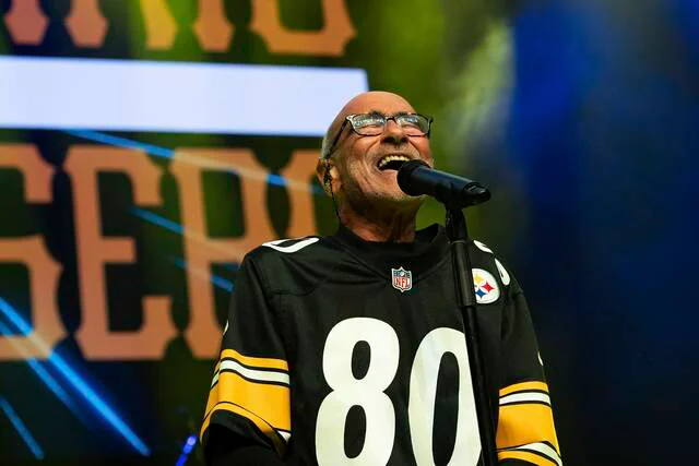 Pittsburgh rock legend Donnie Iris performing onstage with a microphone during a concert