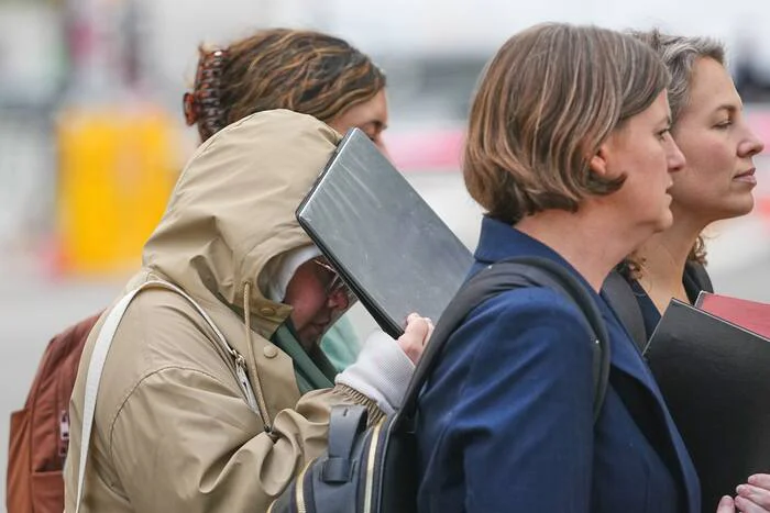 Halima Salman shielding her face while leaving federal court in Brooklyn, New York, on October 21, 2026