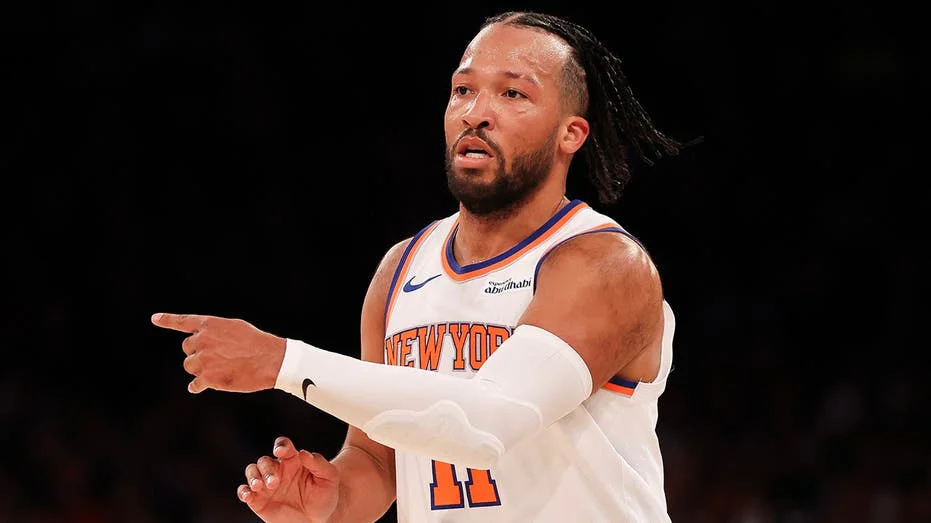 New York Knicks and Detroit Pistons players competing near the basket during an NBA game at Madison Square Garden