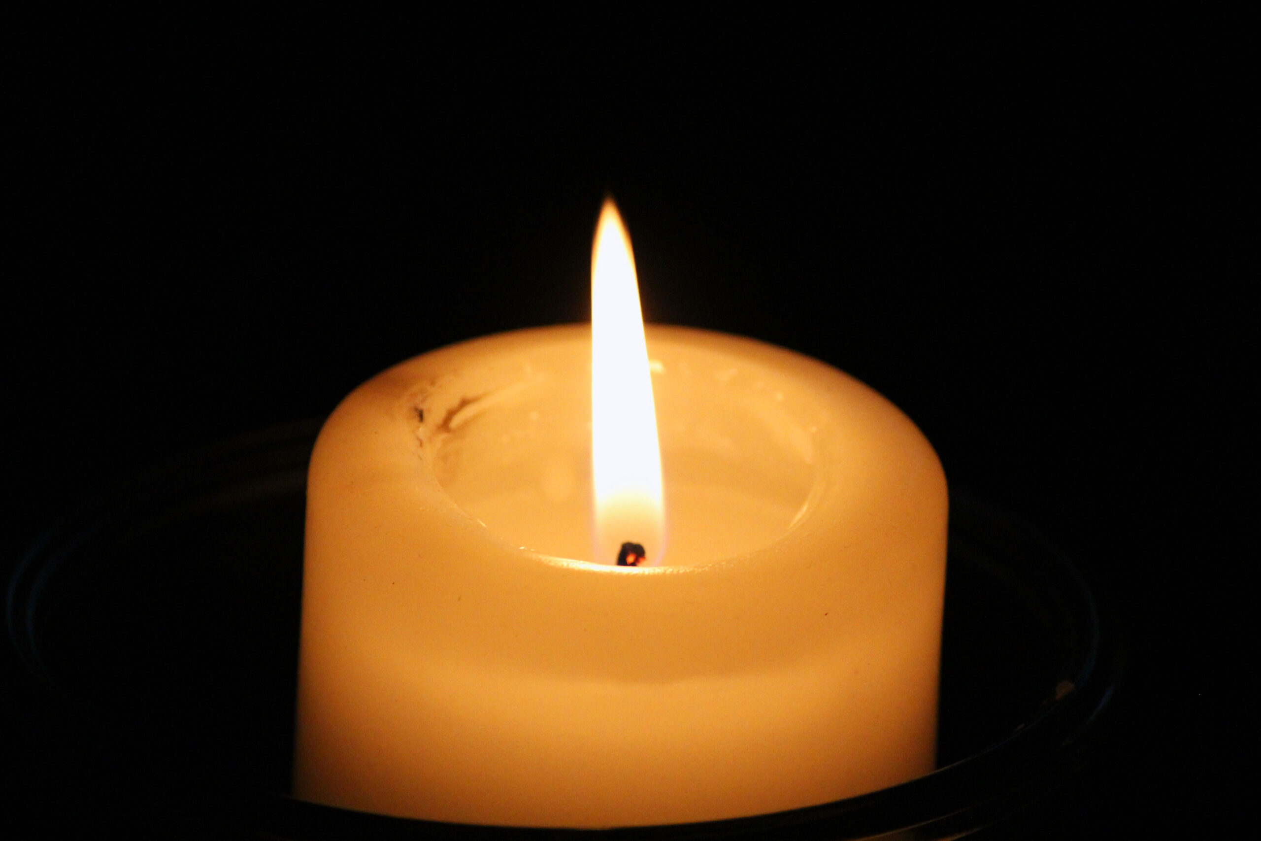 Illustrative file photo: a lit memorial candle